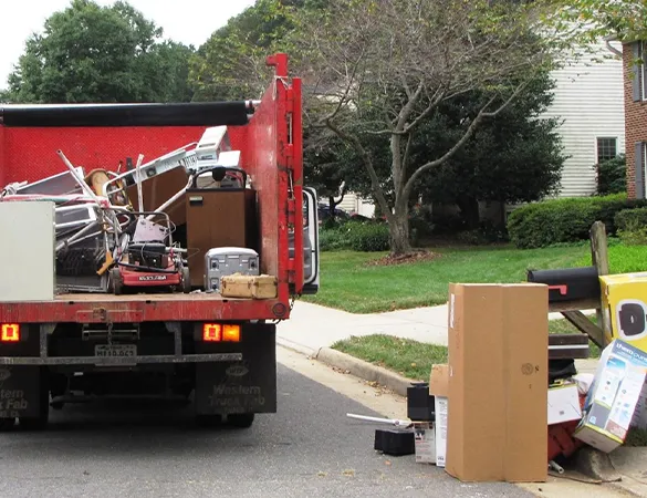 Professional hauling vehicle loaded with various junk items in Hollywood, FL, showcasing comprehensive junk removal services.