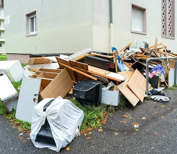 Blue dump trailer used for junk removal, showcasing efficient waste disposal services for residential and commercial properties.